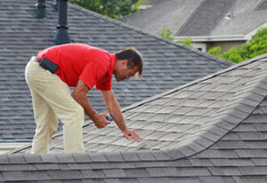 A roof worker checking roof health
